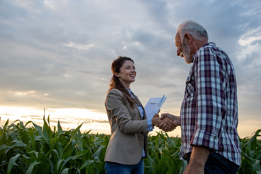 Image of farm visitor shaking hands with a farmer