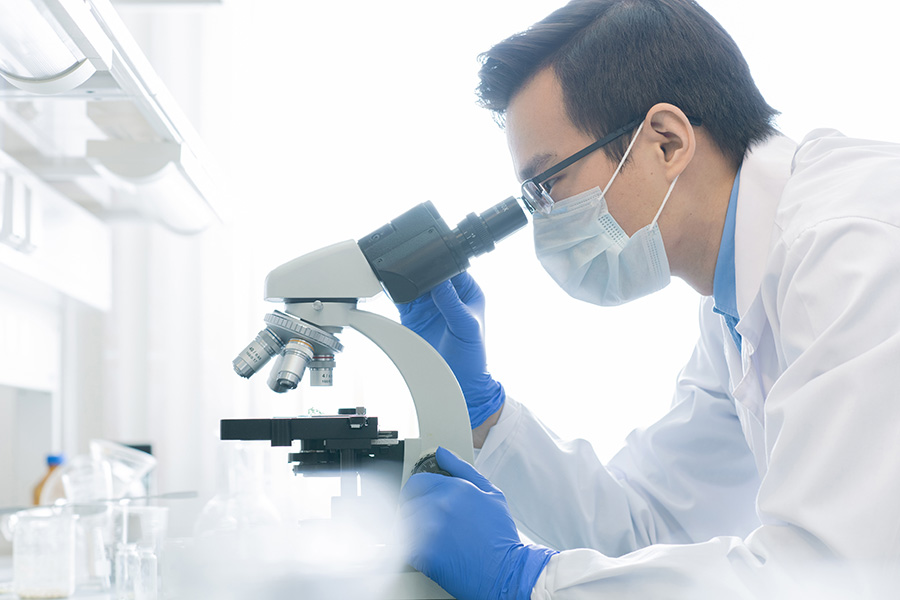 Image of researcher looking into microscope